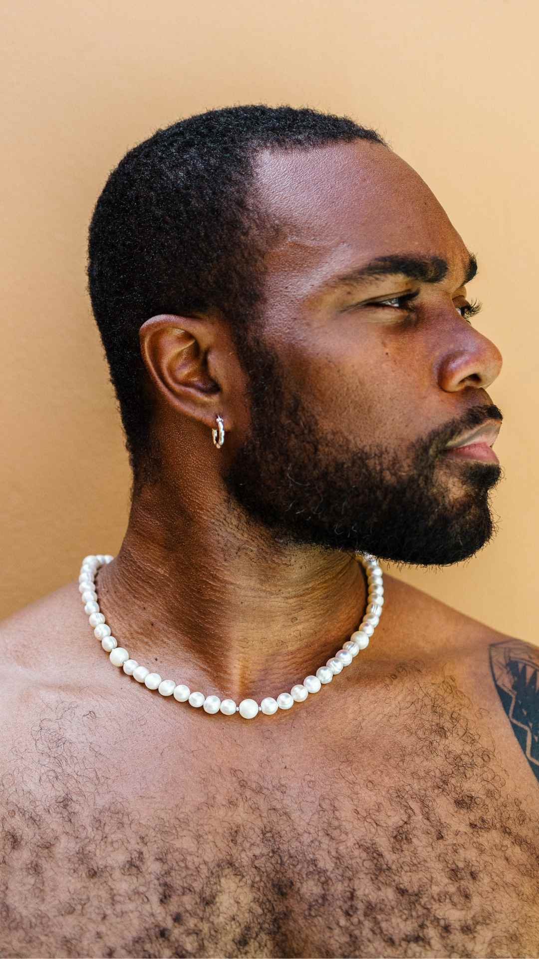 Profile shot of man wearing Chunky 925 Sterling Silver Hoop Earrings paired with South Sea Pearl and Freshwater Pearl Mix necklace.