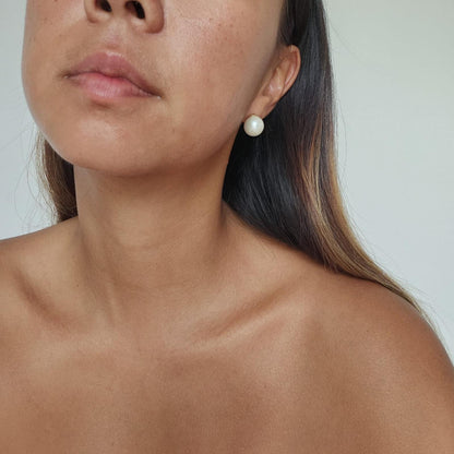 Close up of girl wearing large round white South Sea Pearl Earrings set in 14k Gold Vermeil